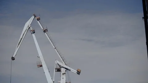 Construction crane lifts the load against the gray sky Stock Footage 105840499