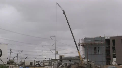 Construction crane lifts a load at a construction site Stock Footage 48827099