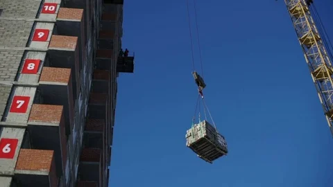 Construction crane lifts stone blocks up Stock Footage 82141652