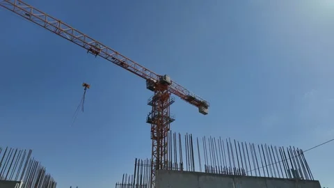 Construction crane lowering hook on building site Stock Footage 333500057
