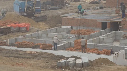 Construction crane lowers a pallet with bricks.  wall construction Stock Footage 120673564