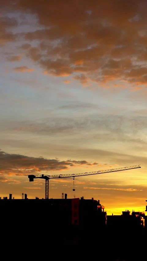 Construction crane in motion at dawn Stock Footage 261730784
