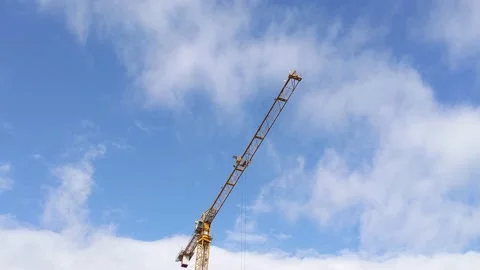 A construction crane moves in the blue sky 스톡 동영상 143443755