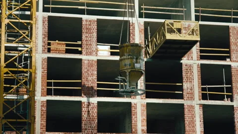 Construction crane moves a concrete container Stockbeeldmateriaal 273148622