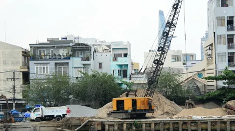 Construction Crane Moving Dirt on a Work Site - Ho Chi Minh City Vietnam Stock Footage 45676212