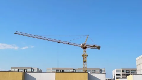 Construction Crane Moving Materials, Heavy Machinery at Work, Building Stock Footage 300600094