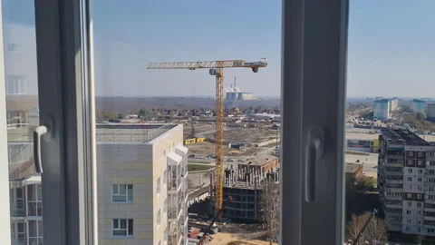 Construction Crane Outside Window. Construction of apartment building. Stock Footage 195283071