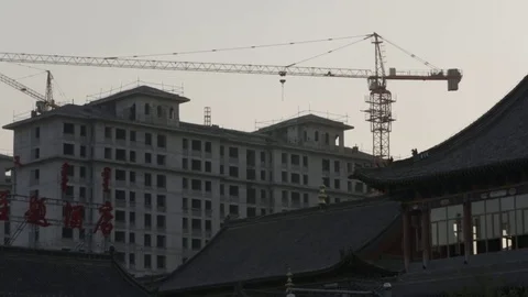 Construction Crane over an almost finished building Stock Footage 72534612