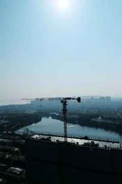 Construction crane over city river skyline Stock Photos