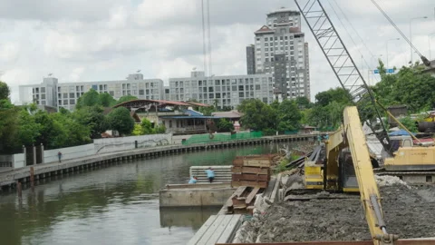 Construction crane over river against Bangkok skyline Stock Footage 345861245