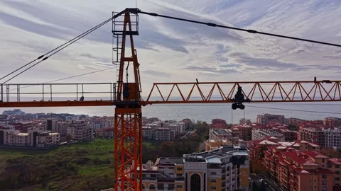 Construction crane overlooking urban development near the coast Video stock 324522261