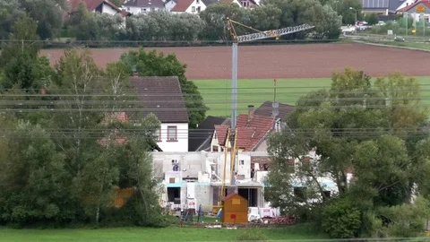 Construction crane, people working on a building site, small rural village, work Video stock 80088578