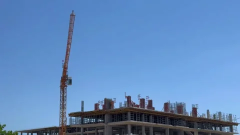 A construction crane performs construction work Stock Footage 279676829