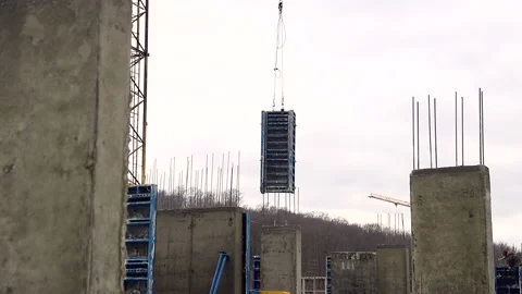 The construction crane raises the weight of the building form for the hardening Video stock 104874171