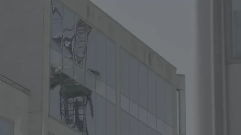 Construction crane reflected in office windows Stock Footage 135197069
