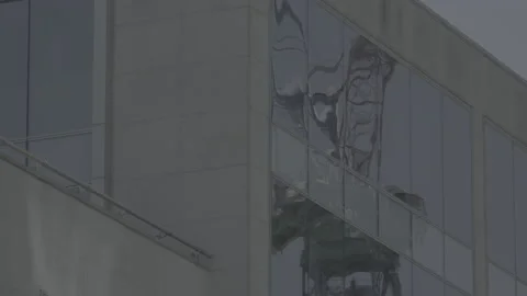 Construction crane reflected in office windows Stock Footage 135197879