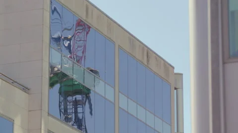 Construction crane reflected in office windows Stock Footage 135199801