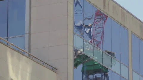 Construction crane reflected in office windows Stock Footage 135200705