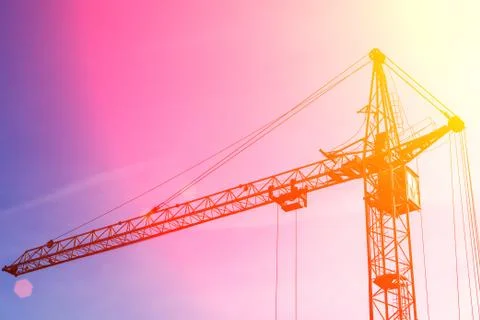Construction crane Self-erection crane at sunset. Construction industrial, sp Fotos de archivo