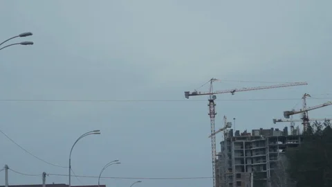 Construction crane silhoette. Construction of a tall building Video stock 104624134