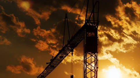 Construction Crane Silhouette Against Dramatic Golden Sunset Sky Stock Footage 341317434