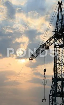 Construction crane silhouette with cool sunset background Stock Photos
