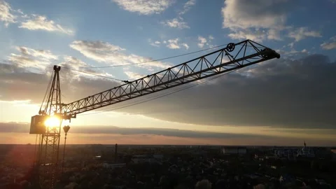 Construction crane silhouette descending at sunset aerial view 스톡 동영상 335405873