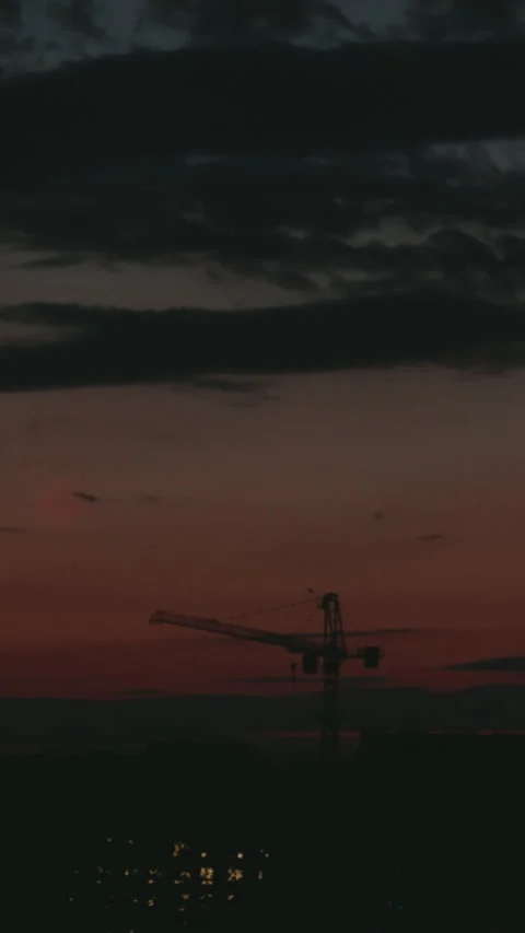 Construction crane silhouette moving at sunset timelapse Stock Footage 345520023