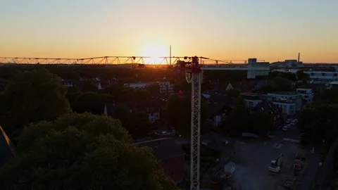 Construction Crane Silhouette at Sunset Over Industrial and Residential Cologne Stock Footage 312526742