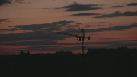 Construction crane silhouette working at sunset timelapse Stock Footage 345520084