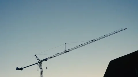 Construction Crane Silhouetted Against a Clear Dawn Sky During Morning 库存影片 331164723