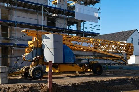 Construction crane on site with building undergoing development Stock Photos