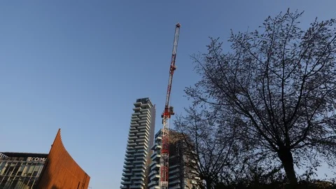 Construction crane with skyscrapers and tree Stock Footage 102145684