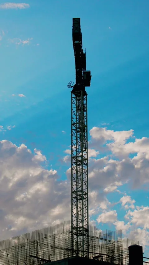A construction crane stands majestically against a breathtaking and scenic sky Stock Footage 291710453