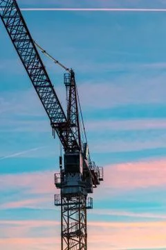 The Construction crane with sunset in the background Stock Photos