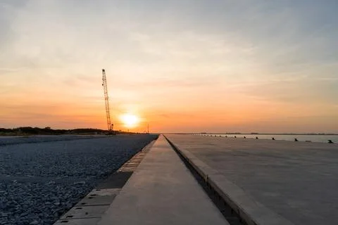 Construction crane on sunset background. Stock Photos