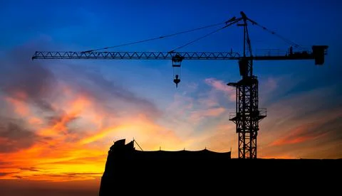 Construction crane on sunset Stock Photos