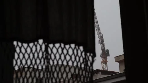 Construction Crane Through Window in Rainy Weather (Time-Lapse) Stock Footage 322124324