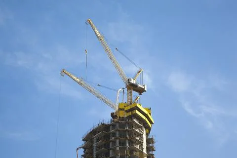 Construction crane tower against a blue sky Stock Photos