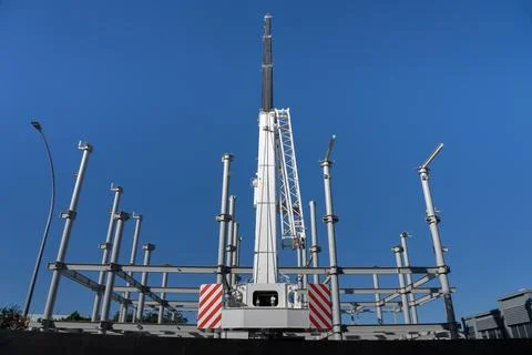 Construction crane towering over structural steel framing for new building Stock Photos