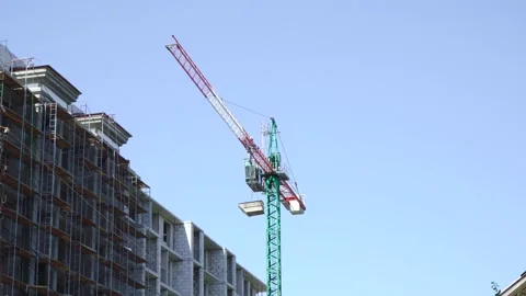 A construction crane transfers structures to the building Video stock 136256058