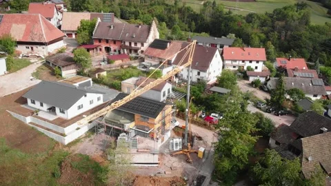 Construction crane transporting and moving windows frames at construction site Stock Footage 206052934