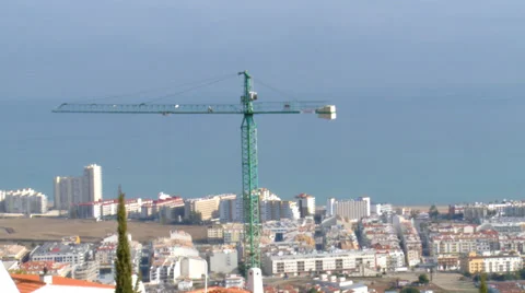 Construction crane turning with sea in background Stock Footage 37243834