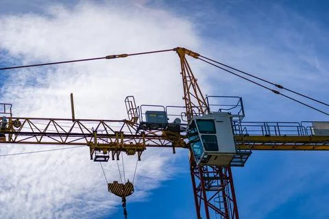 Construction Crane With White Cab Against Blue Sky Stock Photos