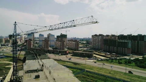 The Construction Crane Is Working .Bird's-eye View Of The Construction Site Of B Stock Footage 121960376
