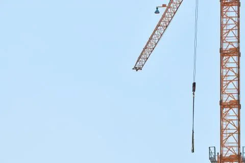 Construction crane working on building complex Stock Photos