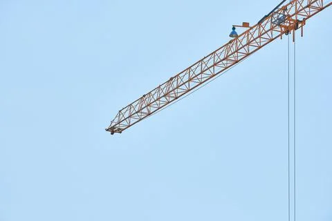 Construction crane working on building complex Stock Photos