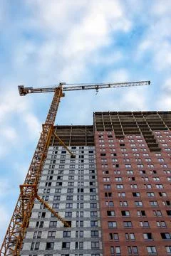 Construction crane is working on the construction of a multi-storey building Stock Photos