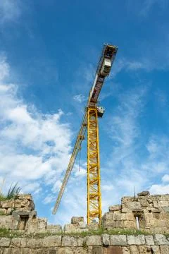 Construction crane working on large construction site Stock Photos