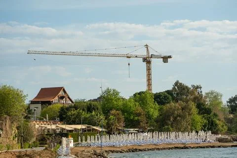 Construction crane working on large construction site Stock Photos